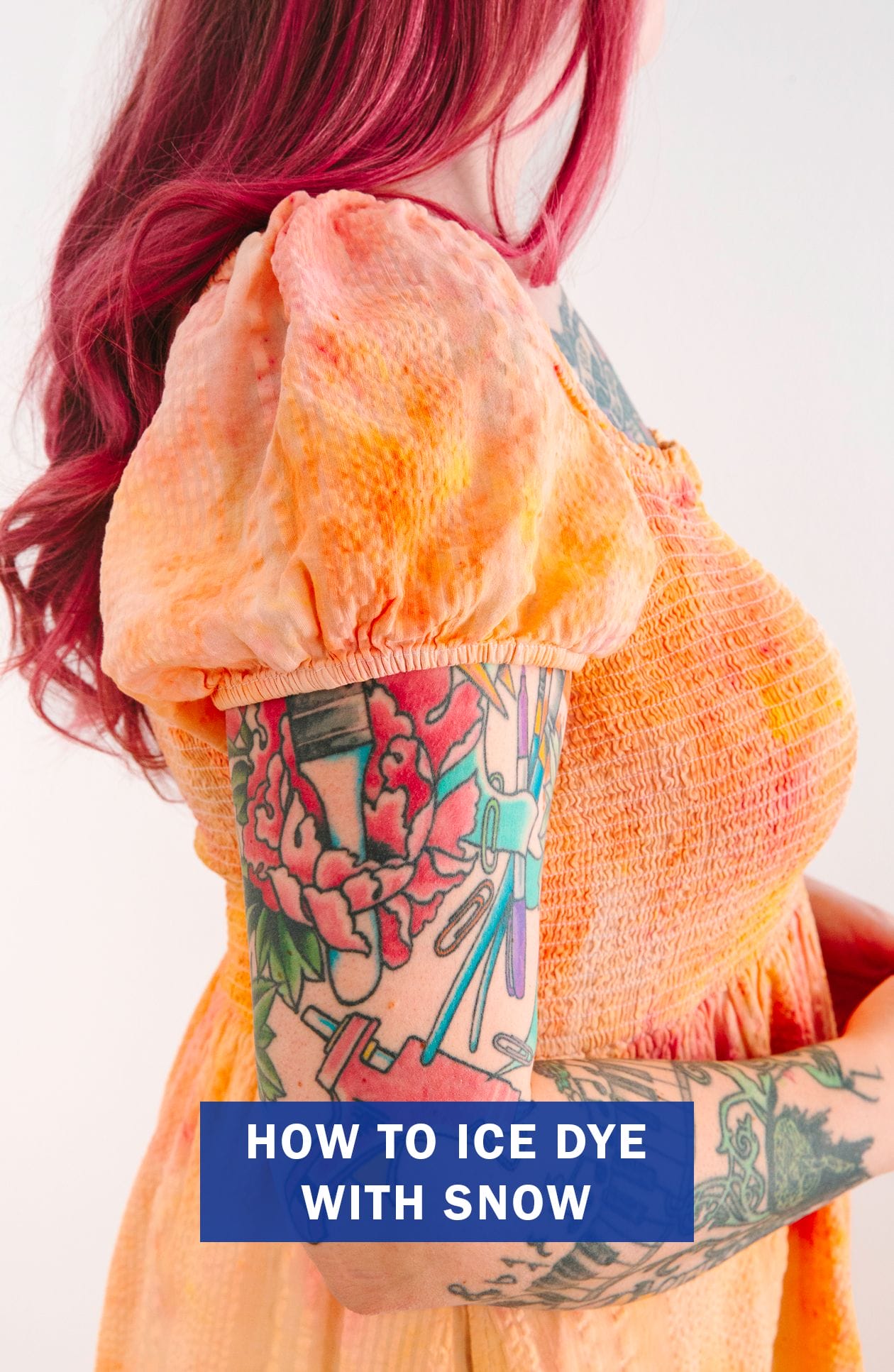 A woman wearing an ice dyed dress in the colors orange, pink, and yellow